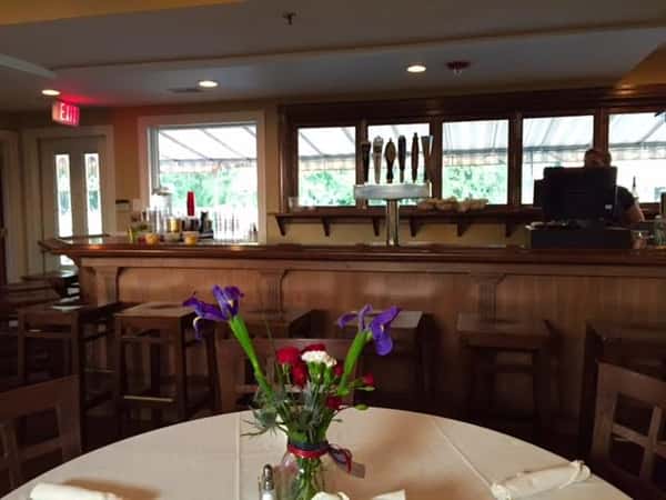 a view of the bar from round table with table cloth