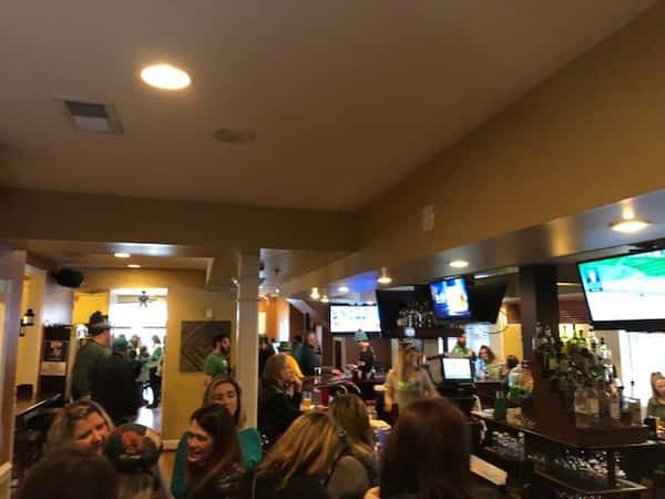 Crowd of people sitting in front of bar