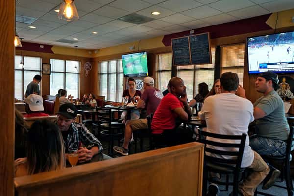 people sitting in the pizzeria at tables