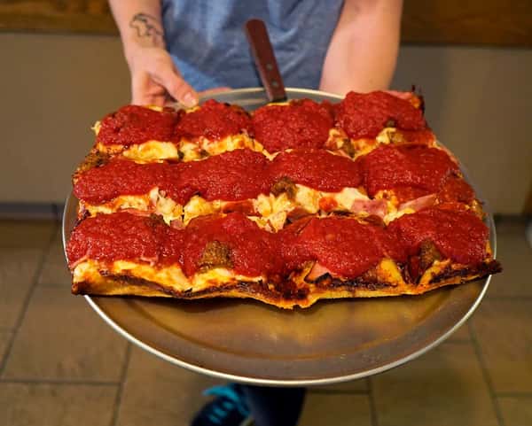 Detroit style square pizza on a tray