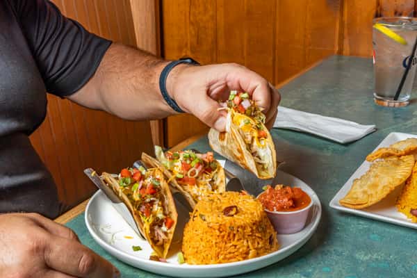 Hand holding a taco