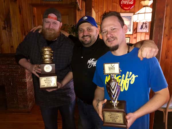 holding trophies