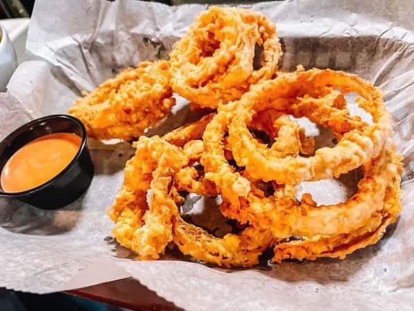 Crispy golden onion rings served with dipping sauce