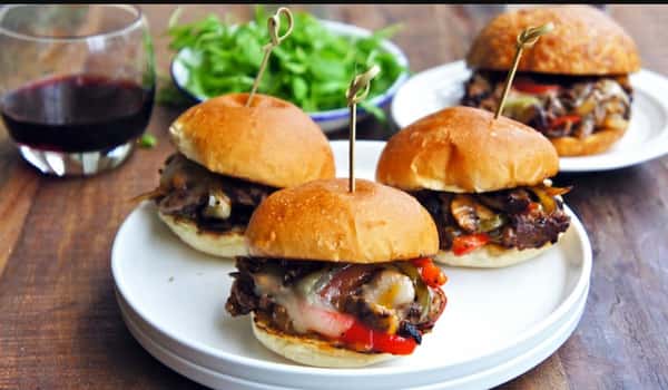 barbecue sandwiches on plates with a side salad
