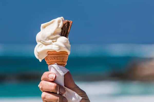 chocolate and vanilla cone being held