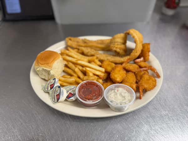 Seafood platter with fried shrimp, fried fish, french fries, a dinner roll, tartar sauce, cocktail sauce, and lemon wedges.