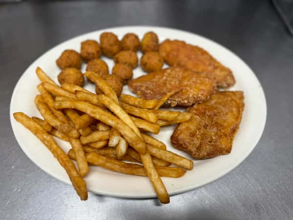 Fried fish fillets with golden French fries and hush puppies on a white plate, served on a stainless steel surface.
