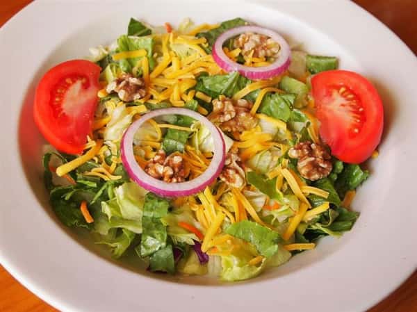 salad with lettuce, tomatoes, cheese, walnuts and onions