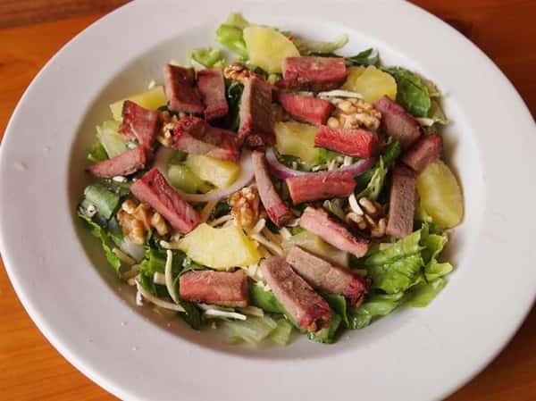 salad with lettuce, steak and pineapple slices