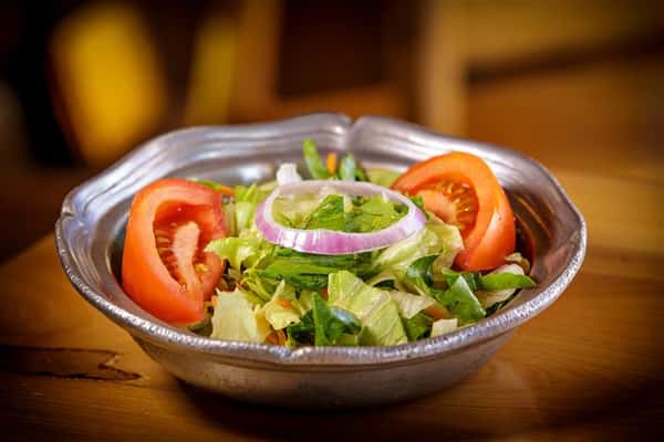 salad in a bowl with tomatoes, onions and lettuce