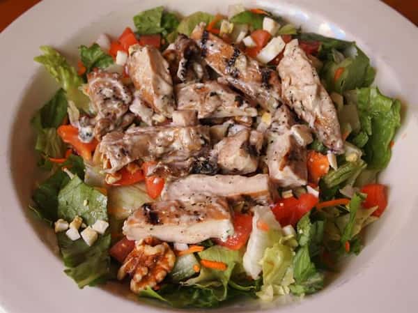 salad with lettuce, tomatoes, cheese, grilled chicken and walnuts