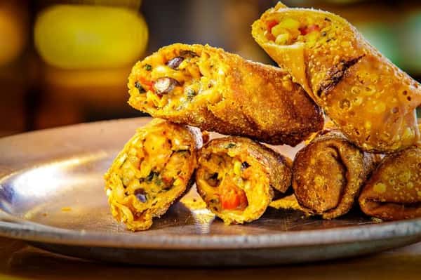 southwest egg rolls stacked together on a plate