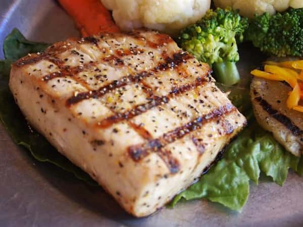 grilled chicken on a plate with roasted vegetables