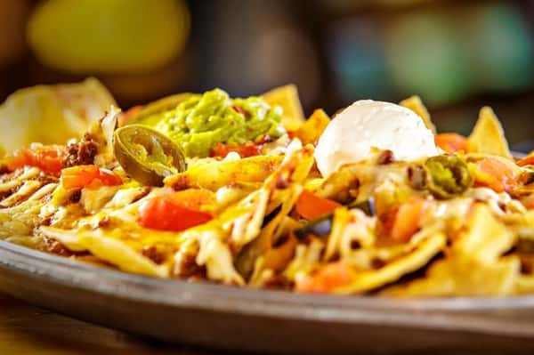 loaded nachos with sour cream and jalapenos