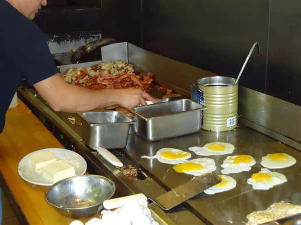 Eggs and bacon being cooked.