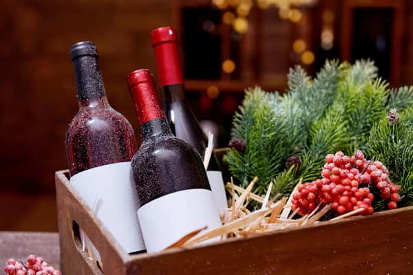 Wine bottles in decorated box on unfocused background