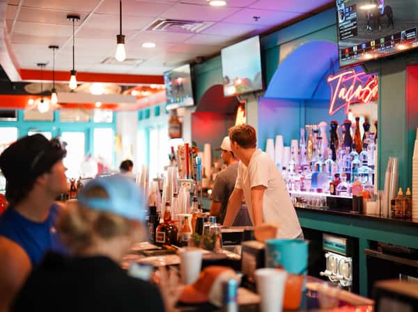 Guests enjoying drinks and conversation at a vibrant restaurant bar.