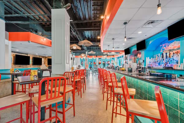 Contemporary dining room with colorful seating and open layout.