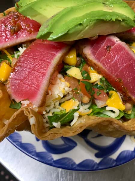 Seared Ahi Tuna Salad from Joselito's Los Angeles, featuring seared ahi tuna, avocado, mango, cheese, and fresh greens in a crispy tostada shell.