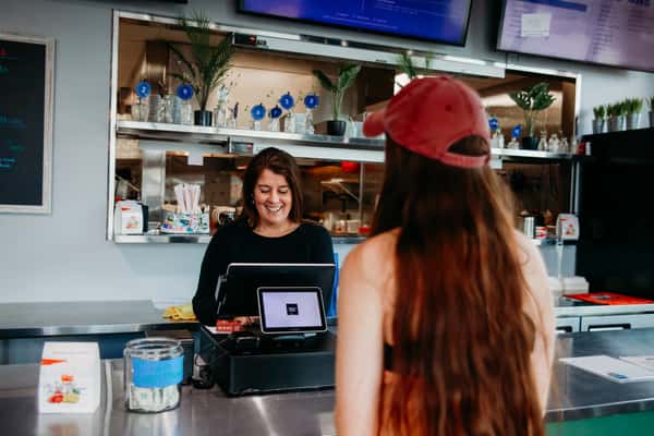 Two employees standing behind the counter at the point of sale.