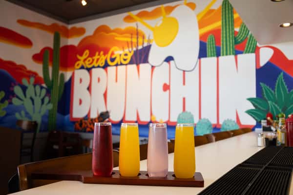 A view of the service counter with a "Let's Brunch" mural in the background.