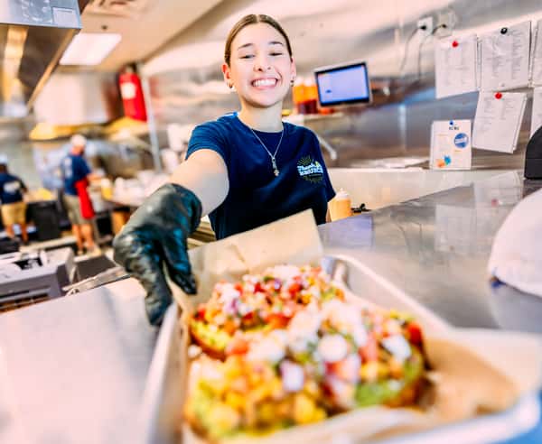 Woman handling food to a customer