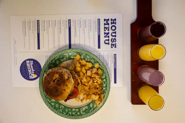 An overhead shot of a burger basket placed on top of a printed paper menu.