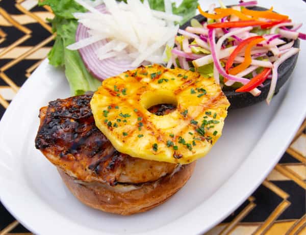Grilled teriyaki chicken sandwich topped with caramelized pineapple, served with slaw and fresh lettuce, onion, and jicama.