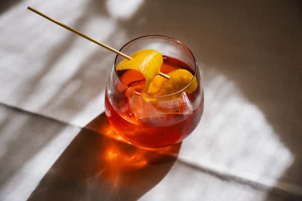 Cocktail garnished with a citrus peel