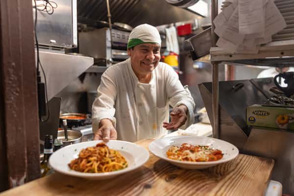 chef serving pasta