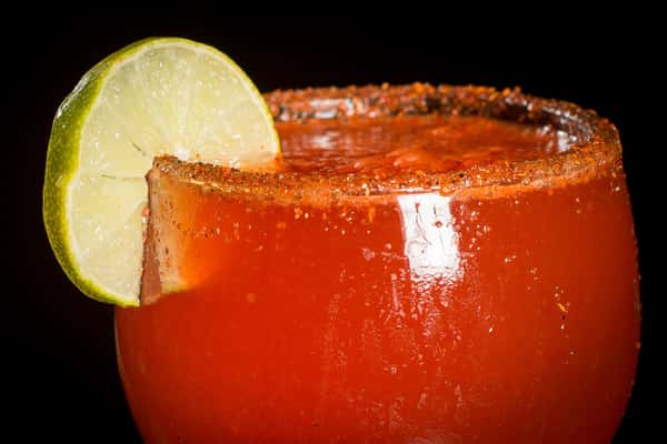 Michelada cocktail with a lime
