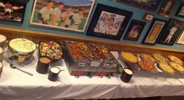 buffet of food on table with pictures on wall
