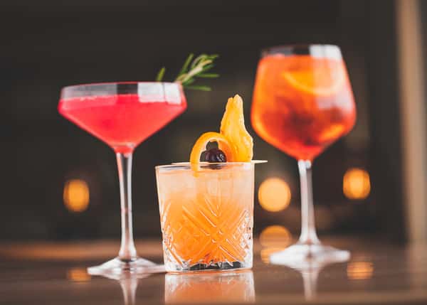 A selection of signature cocktails from La Stalla Osteria & Bar in Stoughton, MA, showcasing vibrant colors and garnishes, embodying the sophisticated ambiance of this Italian dining venue.