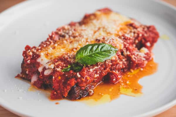 Decadent lasagna with fresh mozzarella, tomato based sauce, and basil.