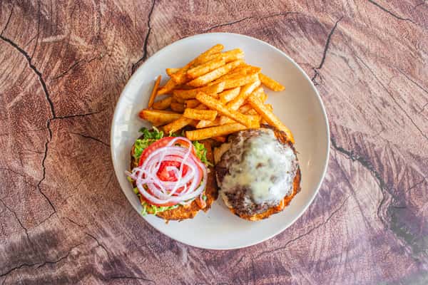A classic cheeseburger served with melted cheese, crisp lettuce, sliced tomato, red onion, and pickle on a toasted bun. Paired with golden French fries and creamy coleslaw, this hearty meal is a timeless comfort-food favorite, perfect for lunch or dinner.