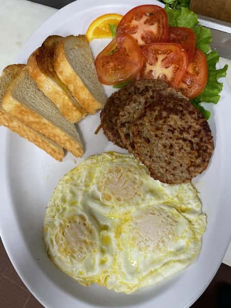 eggs, toast, sausage patties, tomatoes