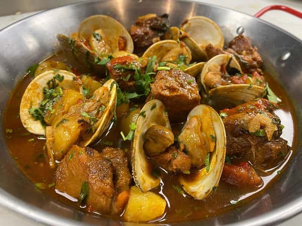Pork and Clams Alentejo is making a comeback evening. This classic Portuguese dish of braised pork, sweet clams, potatoes, piquillo peppers and other aromatics in a luciious gravy is not to be missed.
