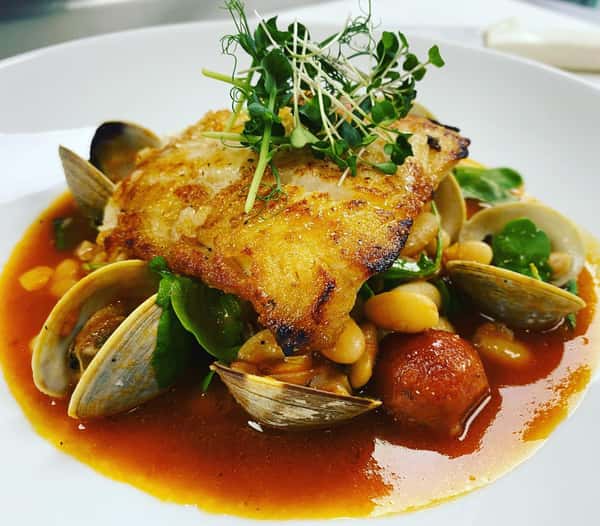 Pan roasted Chatham cod with Portuguese sausage, white beans, baby arugula, tomato broth