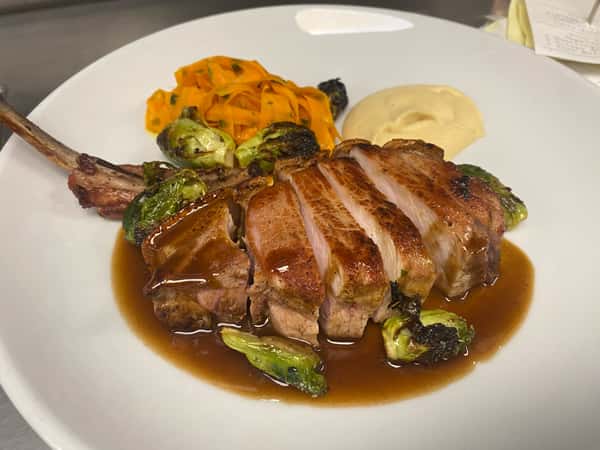 Ferme Gaspor Porcelet chop, apple purée, carrot "fettucini" charred Brussels, cassis mustard jus
