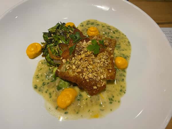 Pan roasted cod, cashew coconut dusted, charred brussel sprout leaves with enoki, carrot miso purée, shrimp nage