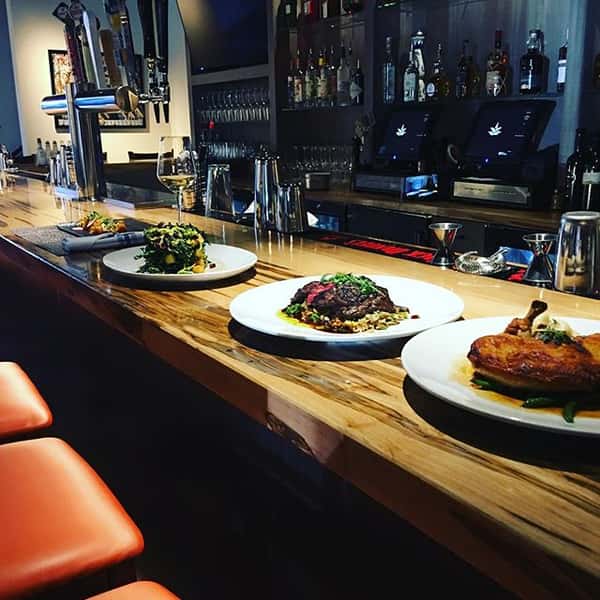 Various plates of food at the bar ( interior)