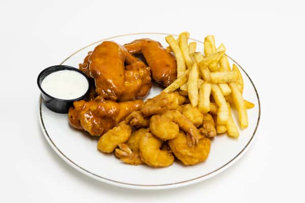 Shrimp buffalo wings and fries dish