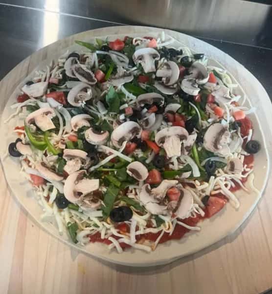 pizza before going to the oven