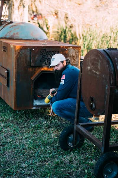 pitmaster tending the smoker
