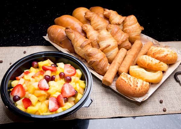 Platter of baked croissants and mixed fruit platter