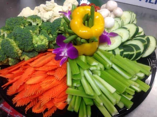 tray of vegetables including carrots, celery, broccoli, cauliflower, peppers, mushrooms and cucumbers