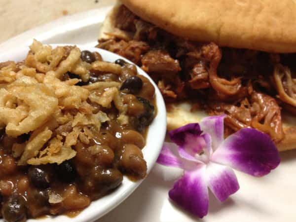 a brisket sandwich with a side of pot pie