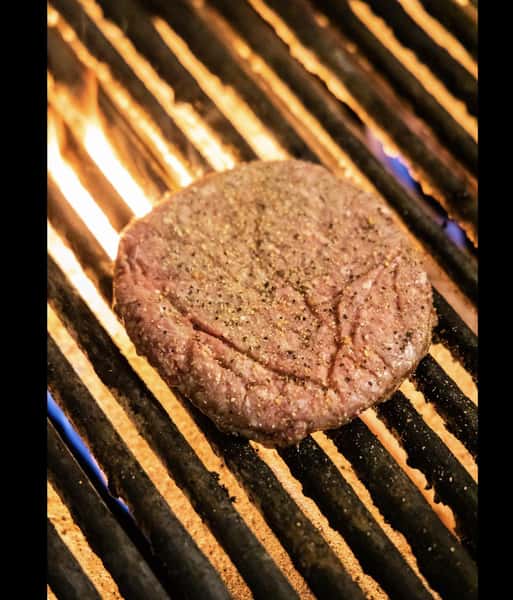 a hamburger patty on the grill