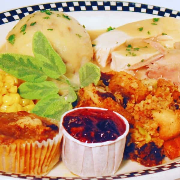eggs benedict with a corn muffin and dipping sauce