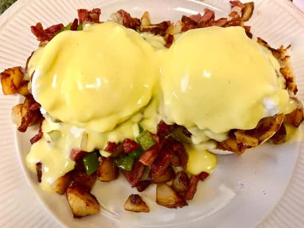 eggs benedict with a side of potatoes